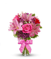 Red roses, pink lilies and pink alstroemeria and glass vase