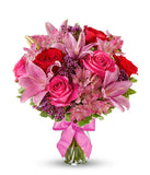 Red roses, pink lilies and pink alstroemeria and glass vase