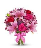 Red roses, pink lilies and pink alstroemeria and glass vase