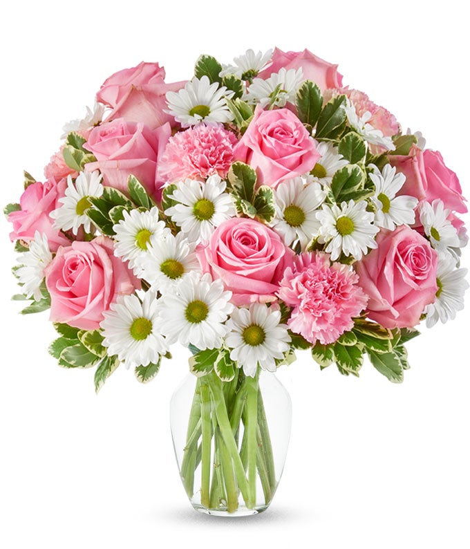 Pink roses, pink carnations and white daisies in a pink vase