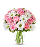 Pink roses, pink carnations and white daisies in a pink vase